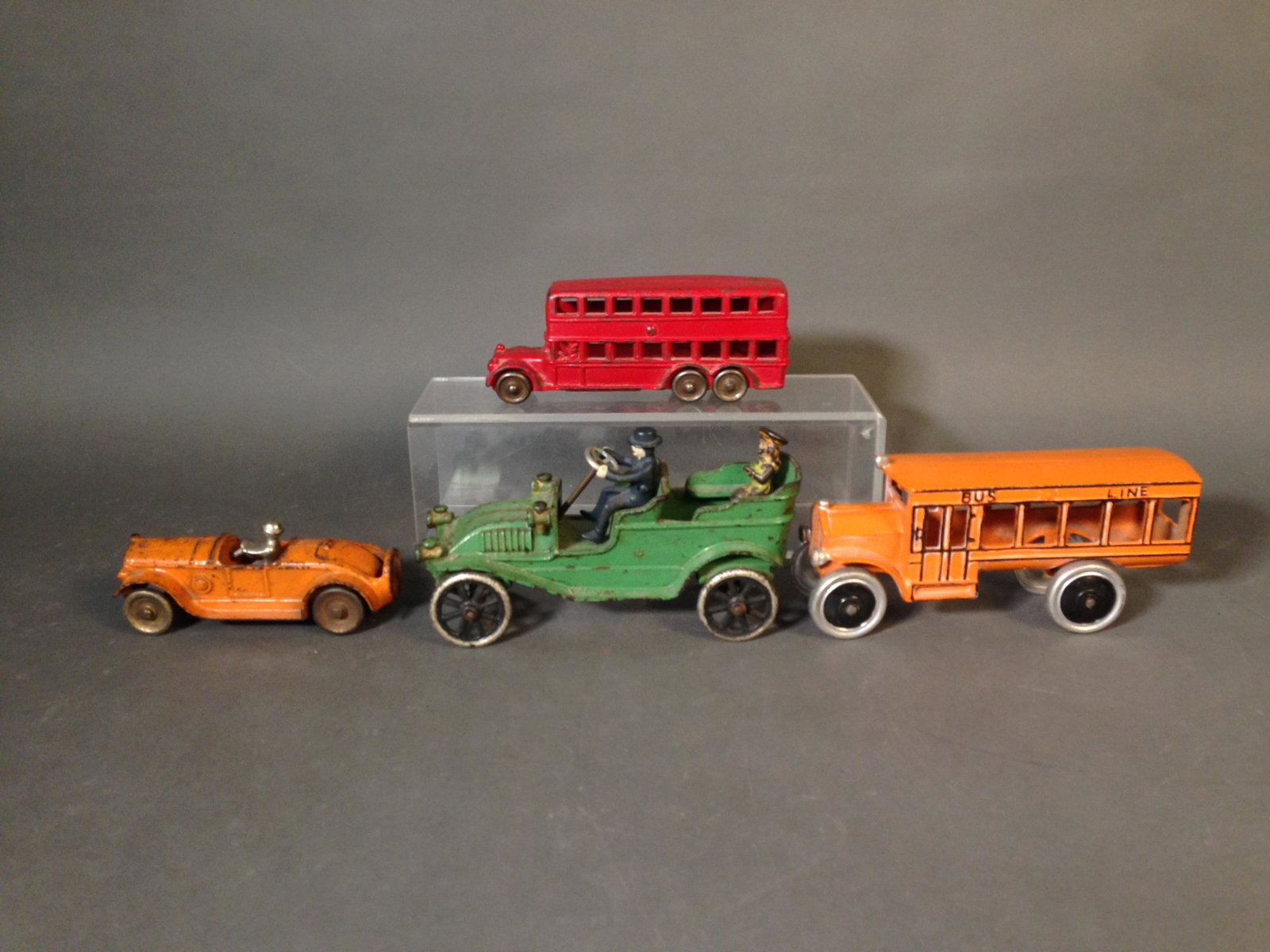 4 Vintage Cast Iron Vehicles, Inc. Dent & Williams: Four Vintage Cast Iron Vehicles ++ Dent Bus Line School Bus, 9" long ++ A.C. Williams double decker bus, 8" long ++ Two unmarked cars, 8" & 6" long Condition: One cars driver's hand is broken off.