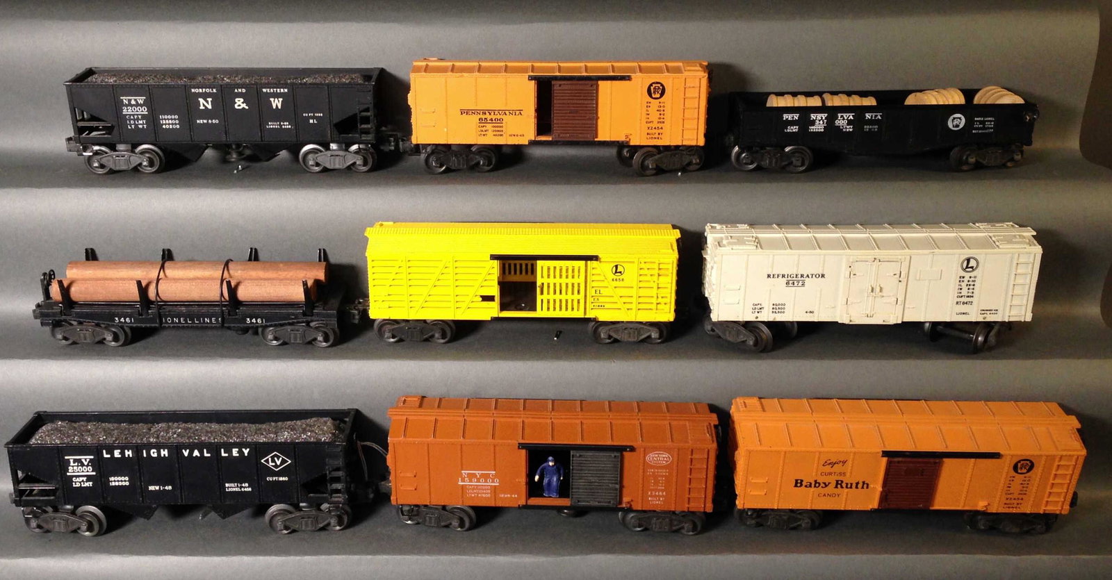 Nine Postwar Staple Truck Lionel Model Train Cars: Nine Postwar Staple Truck Lionel Model Train Cars ++ a pair of 3456 N&Y hopper car, 6472 refrigerator milk car, 2454 box car, 6656 Stock car, 3461 log dump car, 2452 Pennsylvania gondola, 6456 Lehigh 