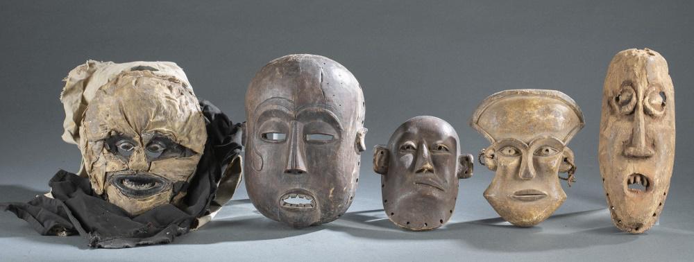 5 African Style Masks. 20th c.: A group of five African style masks. Wood, hide, fabric. 20th century. Largest: 10" x 7" x 3 1/2". Smallest: 7 1/2" x 5 3/4" x 2 1/2". Condition: Accretions and wear throughout.