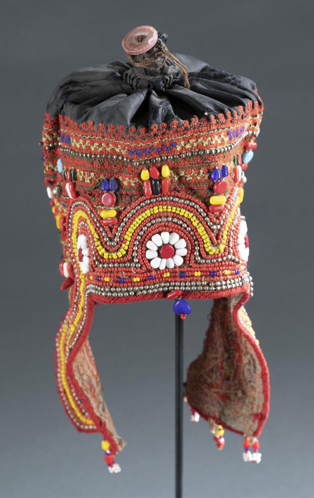 Northern Pakistan Embroidered Hat.: A beaded and embroidered hat from Northern Pakistan. 20th century. 9 1/2" x 5 1/2". Condition: May not include stand.