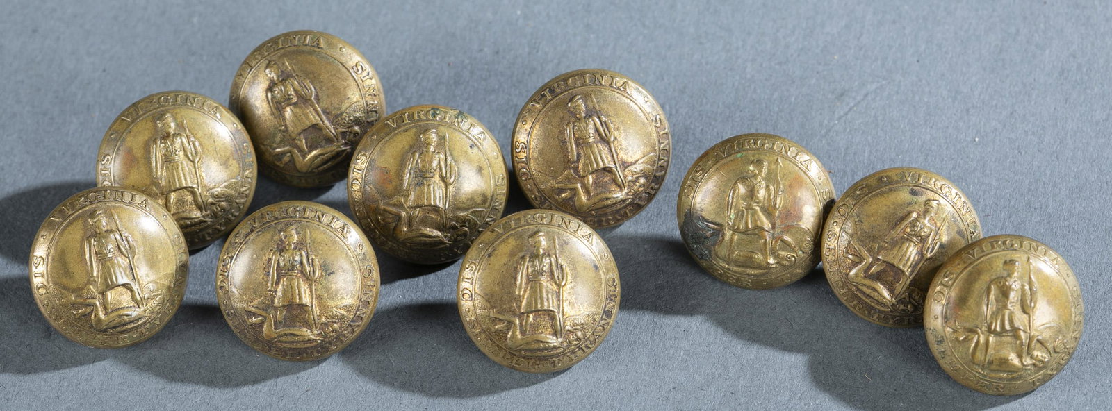 10 Horstmann Bros., Virginia Buttons.: [Uniforms] A group of ten Horstmann Bros and Allien Virginia state seal buttons. Depicts Virtus slaying tyrant with state motto. Marked on front "Virginia Sic Semper Tyrannis." Marked on back "Horstma