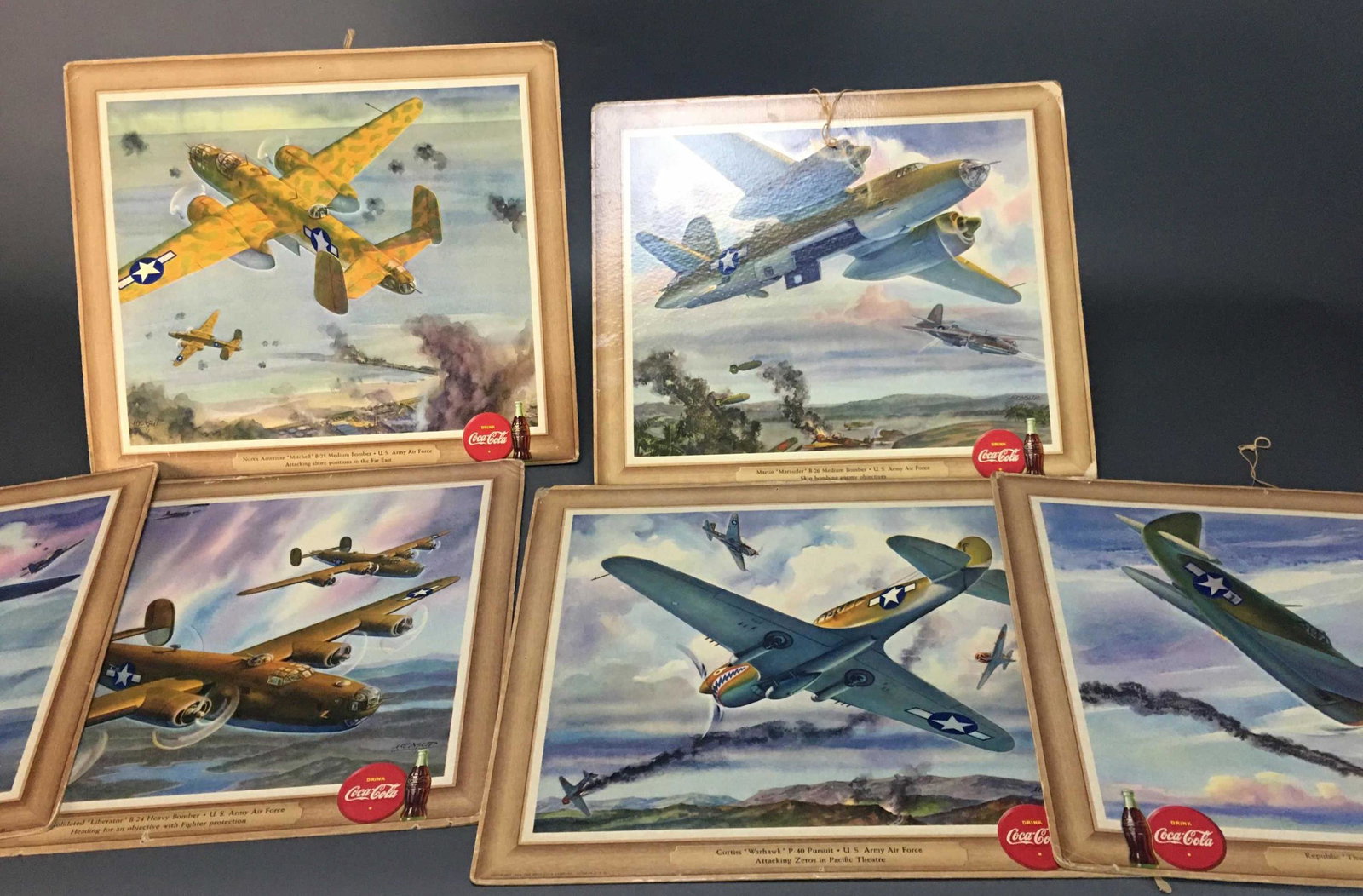 7 WWII Coca-Cola Ads By Heaslip. Litho. 1943.: [Art] 7 WWII Coca-Cola litho ads featuring various airplanes. Drawings by William John Heaslip. All copyright 1943. Glossy images on cardboard. Measure 13" x 15"._x000D_ Condition Wear to corners. Pin