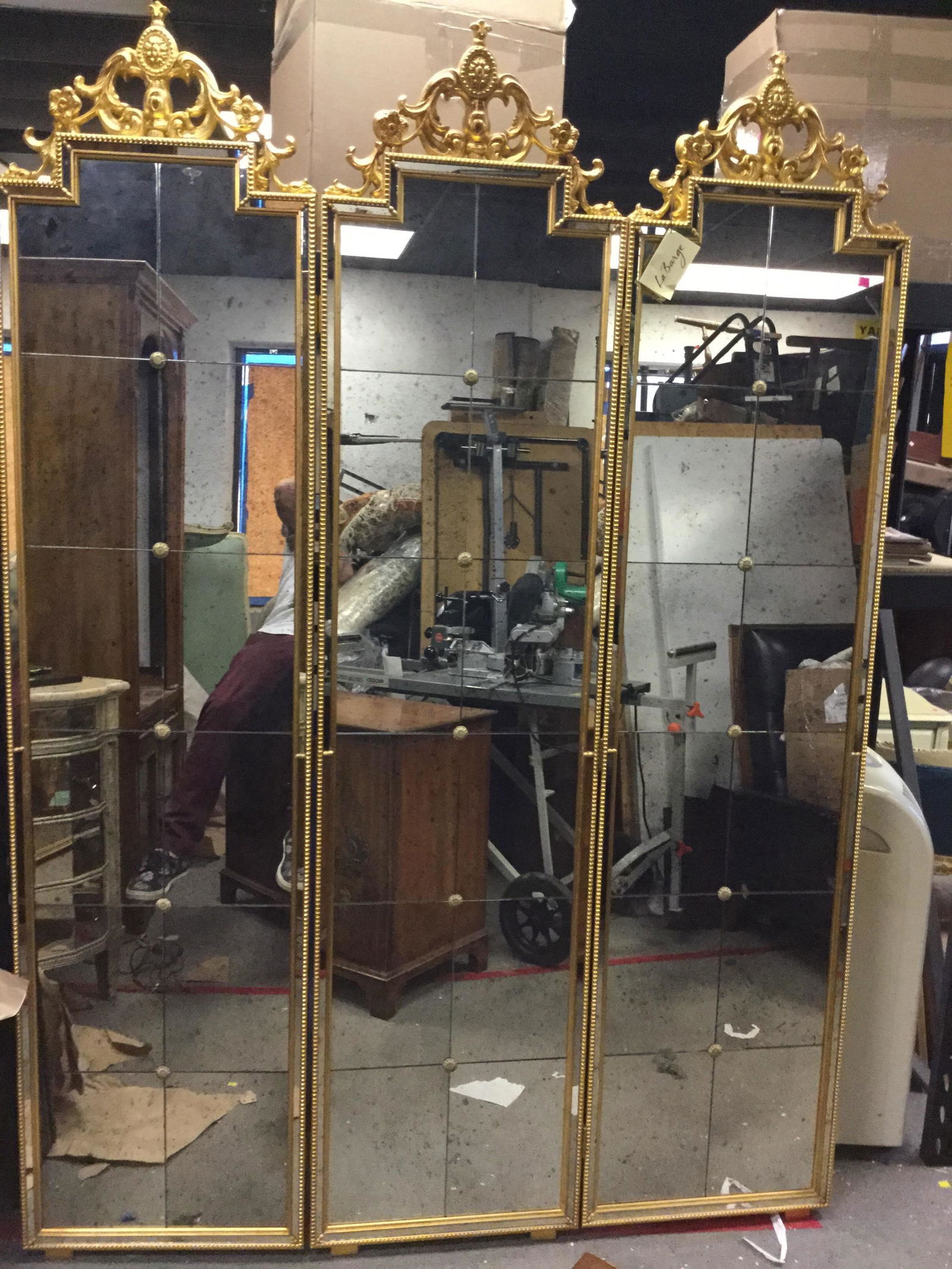 La Barge, tri fold mirror screen: A La Barge tri fold mirror screen in antiqued gold tone frame. Paper label on back. Measuring: 61" x 86"