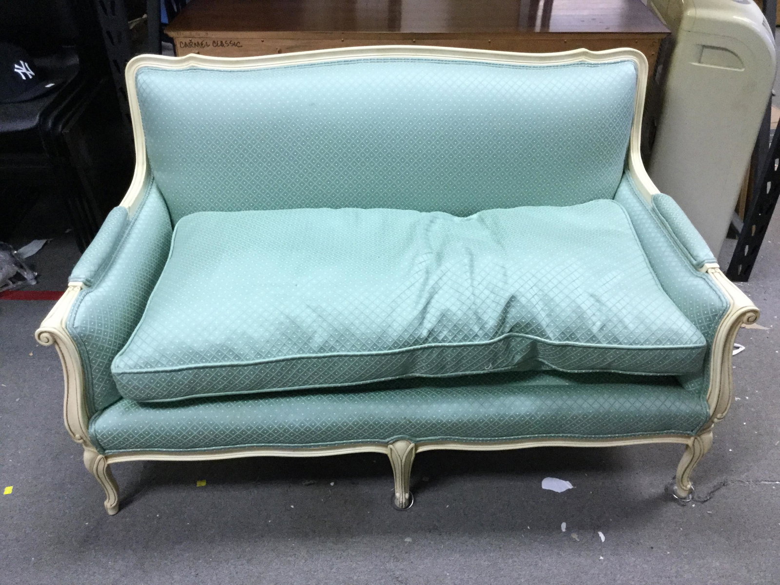 French Provincial style painted settee: A French Provincial style painted settee. Framed painted white and upholstered cushion seat. Measuring: 32" x 53" x 28" Matching pair with lot 141.