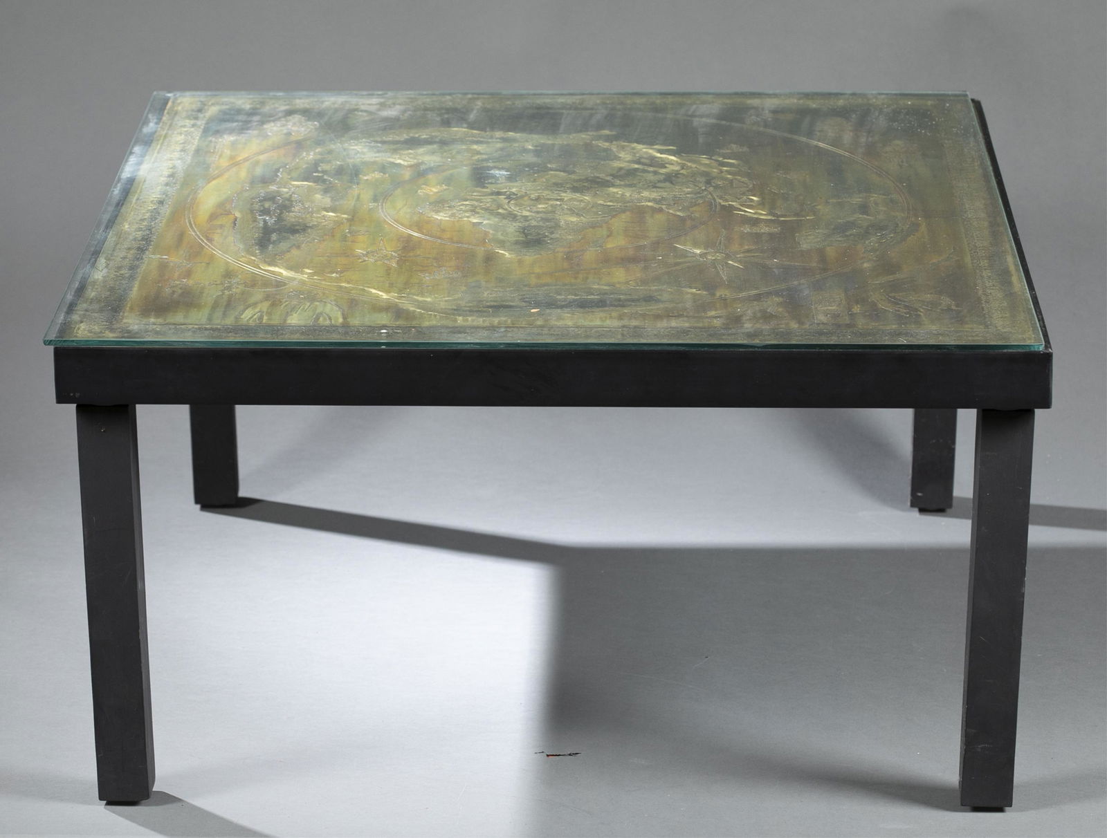 Bernhard Rohne, etched bronze, 1973.: Rohne, Bernhard (German, b. 1944). Untitled. 1973. Etched and treated bronze wall plaque, converted into table-top. Bronze depicts world map and figural images within geometric border. Includes glass