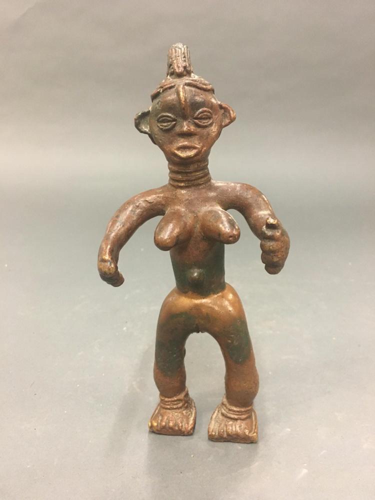 Dan Metal Female Figure. 20th c.: A Dan metal female figure. Ivory coast/Liberia. Brass/Bronze. 20th century. Neck rings, sandals and snake on back. Approx. 8" x 3 1/4" x 2 1/2". Discoloration throughout. Condition: Discoloration thro