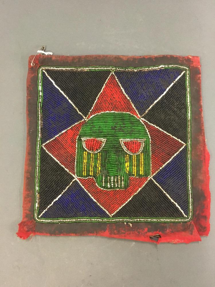Yoruba Beaded Bag Panel. 20th c.: A Yoruba beaded bag panel. Nigeria. Beaded panel on red cloth. Nigeria. 20th century. Approx. 10" x 10" x 1/4". Red cloth fraying at bottom. Accretions throughout. Condition: Red cloth fraying at bott