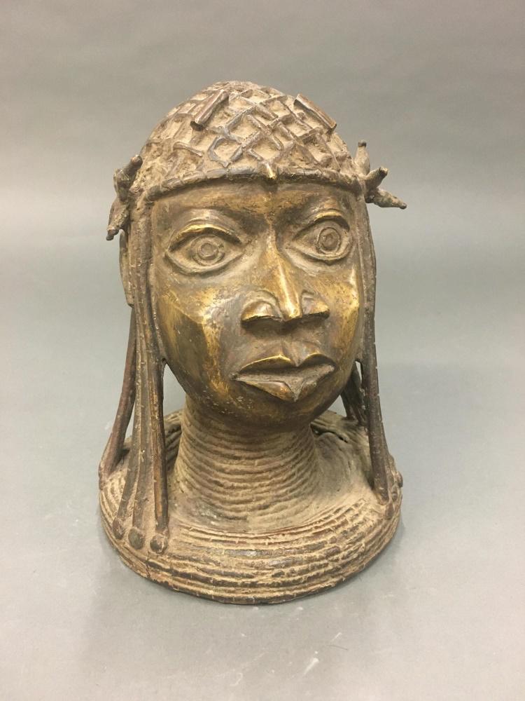 Benin Style Brass Head of an Oba. 20th c.: A Benin style brass head of an Oba. West Africa. 20th century. 9" x 7 1/2" x 7 1/2". Condition: Some cigarette odor.