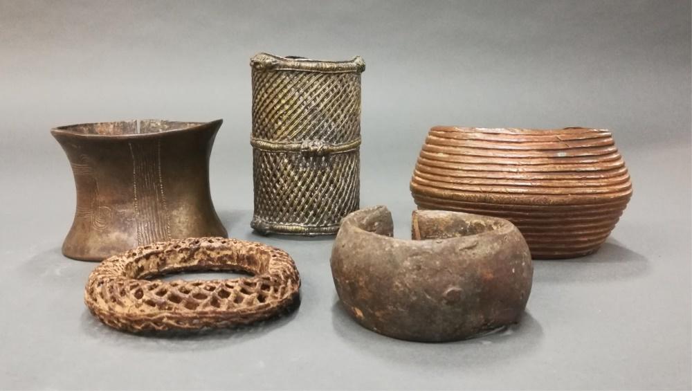 5 Bracelets & Anklets from West Africa. 20th c.: A group of five bracelets and anklets from West Africa. 20th century. ++ Brass bracelet. 3 1/4" x 4". ++ Metal bracelet. 4" x 3/4". Damage to metal latticework. ++ Benin style brass cuff. 4 3/4" x 3".