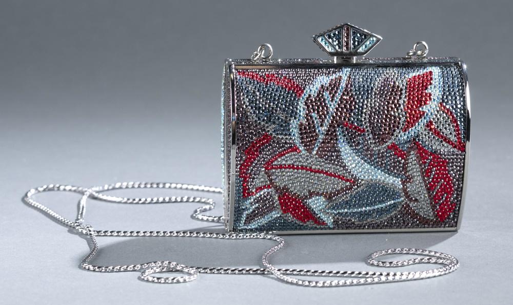 Judith Leiber, crystal minaudiere: A Judith Leiber crystal minaudiere. Pentagon shaped latch closure. Blue, red, purple, and silver crystals in leaf pattern on silver tone frame. Marked on interior. Includes silvertone shoulder chain,
