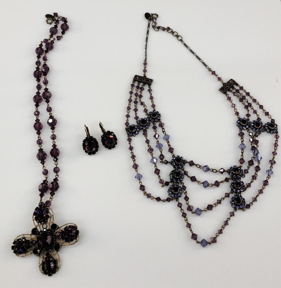 3 Liz Paiacios necklaces and earrings.: A group of three Liz Paiacios pieces of jewelry with purple stones and beads. Stamped. ++Lever back earrings. 1". ++ Beaded necklace with cross shaped pendant and springring clasp. 17". ++ Collar neck