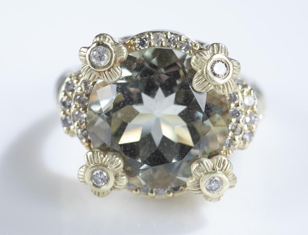 Judith Ripka, 14k green quartz ring.: A Judith Ripka 14k ring. Green quartz set in four flower shaped prongs with cubic zirconia and surrounded by pave cubic zirconia. Stamped inside band. Size 7 1/2. Approx, 11g.