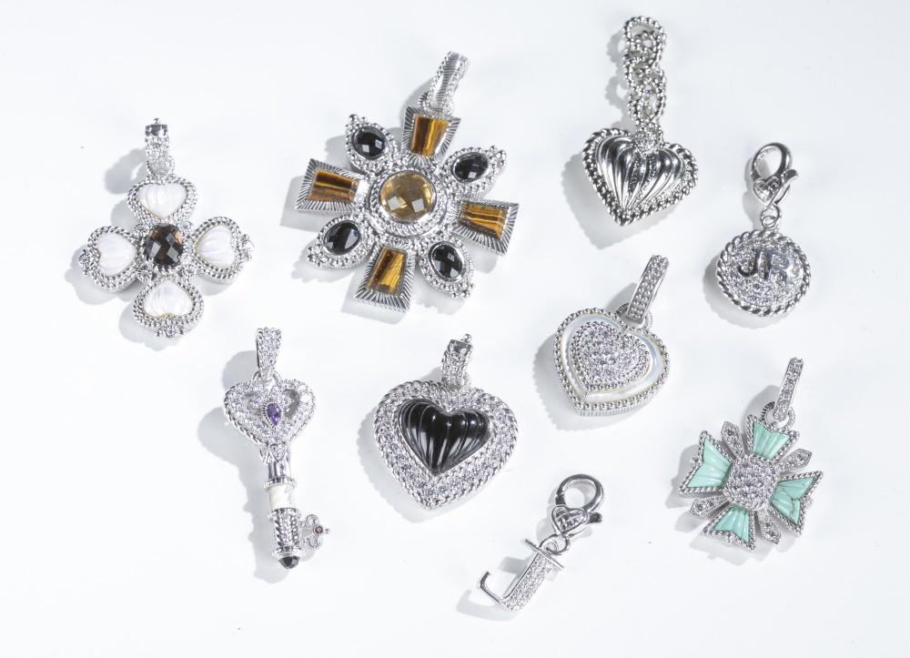 9 Judith Ripka, pendants & charms.: A group of nine Judith Ripka pendants and charms. ++Sterling silver Maltese cross pendant with a center of pave cubic zirconia and light green stones at the points. Snap hinge bail. Stamped on back. 1