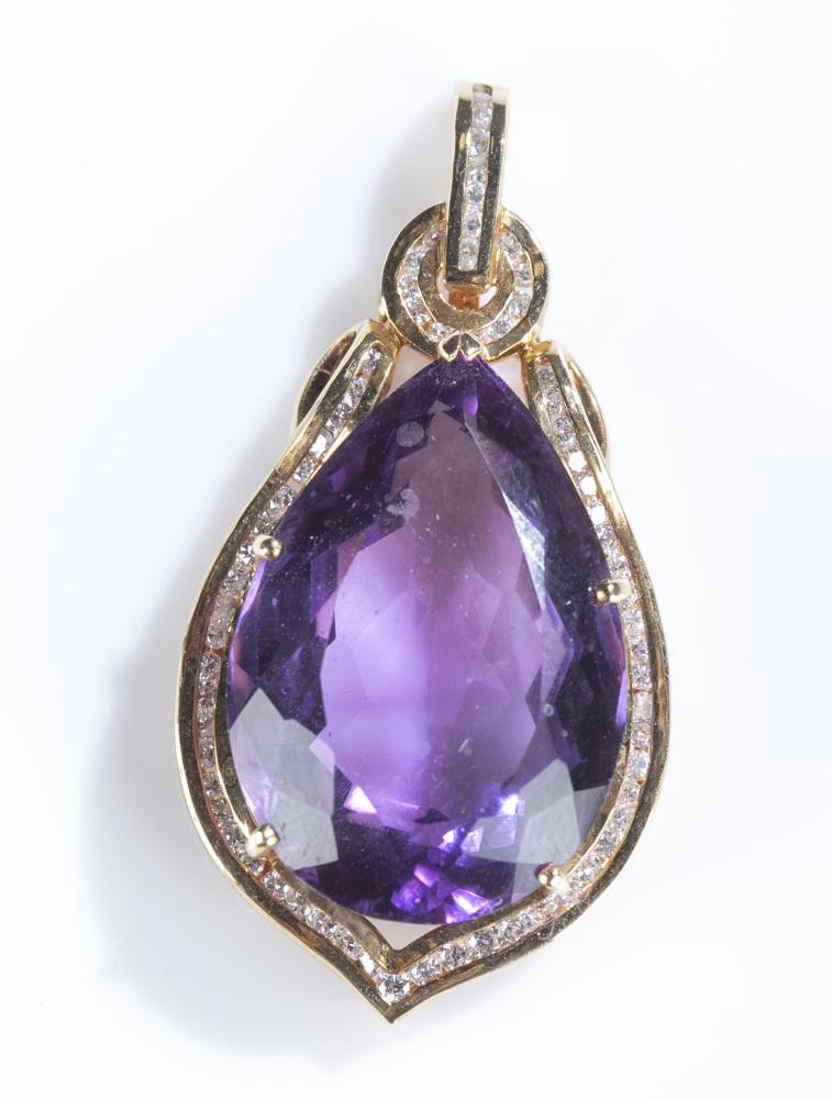 Cartier, amethyst 14k gold pendant.: A Cartier amethyst 14k gold pendant. Pear cut amethyst in five prong 14k gold and diamond setting. Marked on back. 1 3/4" x 3/4". Approx. 12.7 g.