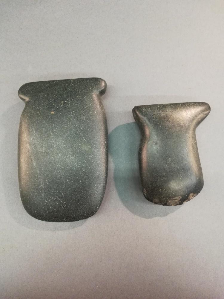 2 Montena Greenstone Axe Heads. 800-1200 CE.: A group of two Montena greenstone axe heads. Ecuador. 800-1200 CE. ++ Larger 5 1/4" x 3 1/4" x 1". ++ Smaller 4" x 3" x 1".