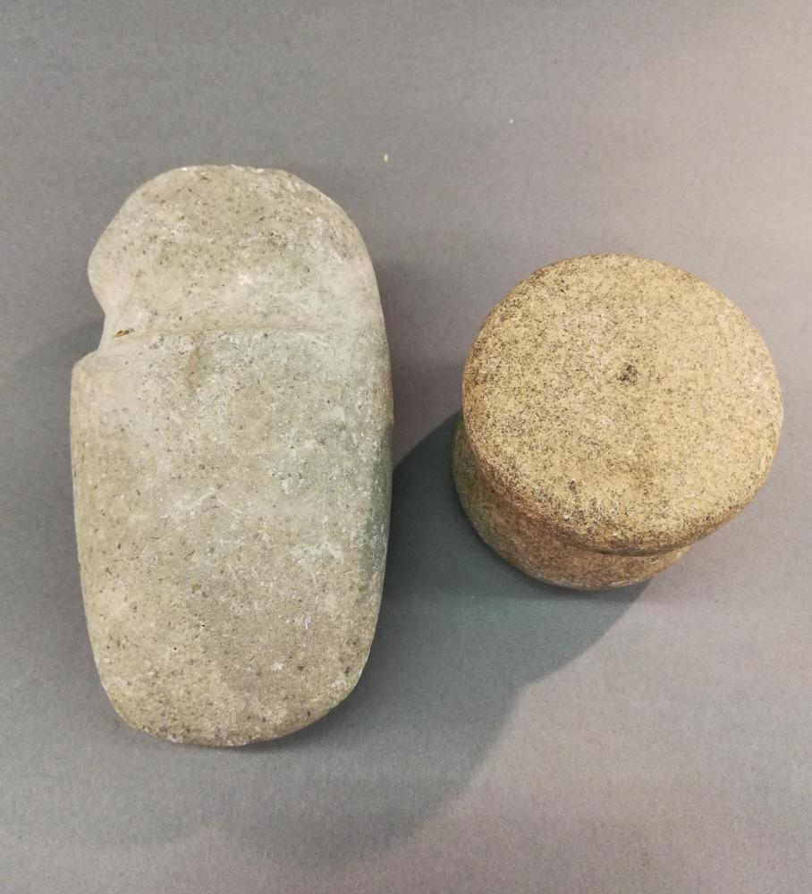 2 Pre-Columbian Stone Objects, Mexico.: A group of two Pre-Columbian stone objects. Mexico. ++ Nayarit axe head. Circa 500 BCE. 7 1/4" x 4" x 3".++ Sinaloa pounder. Circa 600 CE. 3 1/4" x 3 1/2".