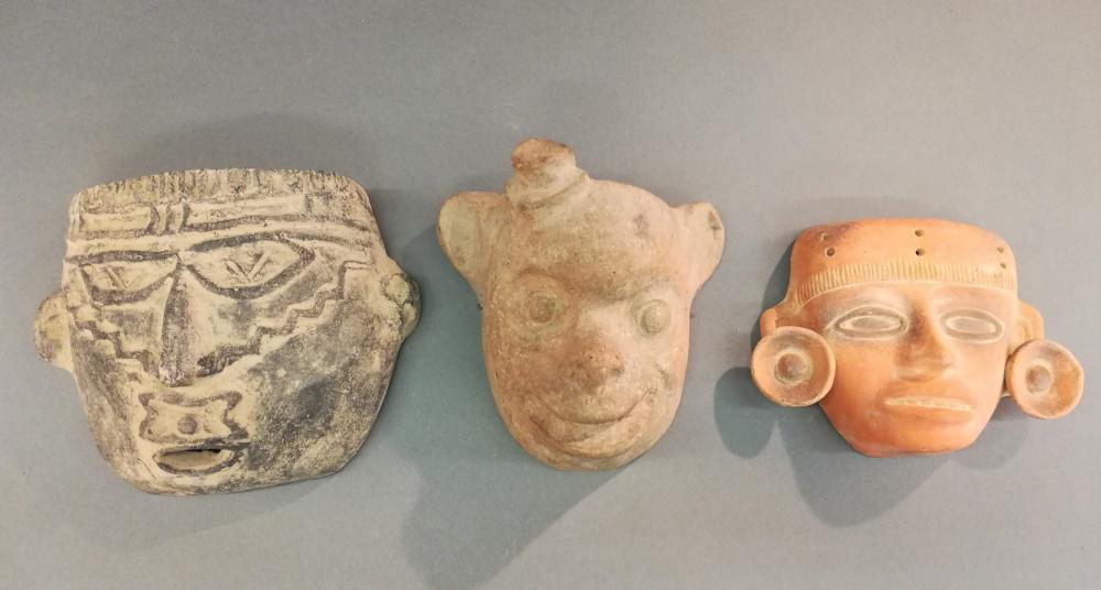 3 Pre-Columbian Style Terracotta Masks. 20th c.: A group of three Pre-Columbian style terracotta masks. 20th century. ++ 7 1/2" x 10" x 3 1/2". ++ 8 3/4" x 7 3/4" x 3 3/4". ++ 6 1/4" x 8 1/4" x 2 1/4".