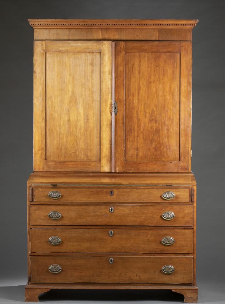 Federal style, pine secretary desk.: A Federal style secretary desk. 19th century. Cornice with dentils. Double-door opens to cabinet with top drawer beneath cornice, open shelves, and drawers and arched pigeon holes. Drop-front desk wit