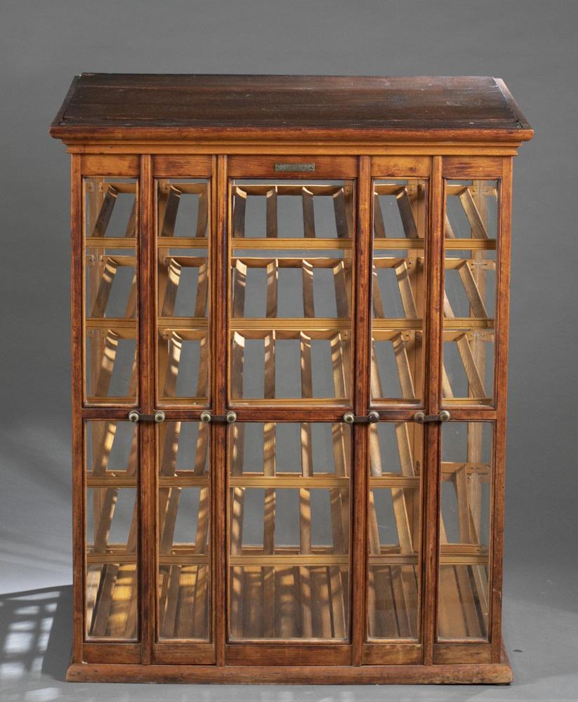 Exhibition Showcase Co., ribbon spool cabinet.: An Exhibition Showcase Company ribbon spool cabinet. Erie, Pennsylvania & Guelph Ontario. Oak frame with glass doors and panels. Henrich's Patent November 1883. Haberdashery ribbon spool cabinet. Stat