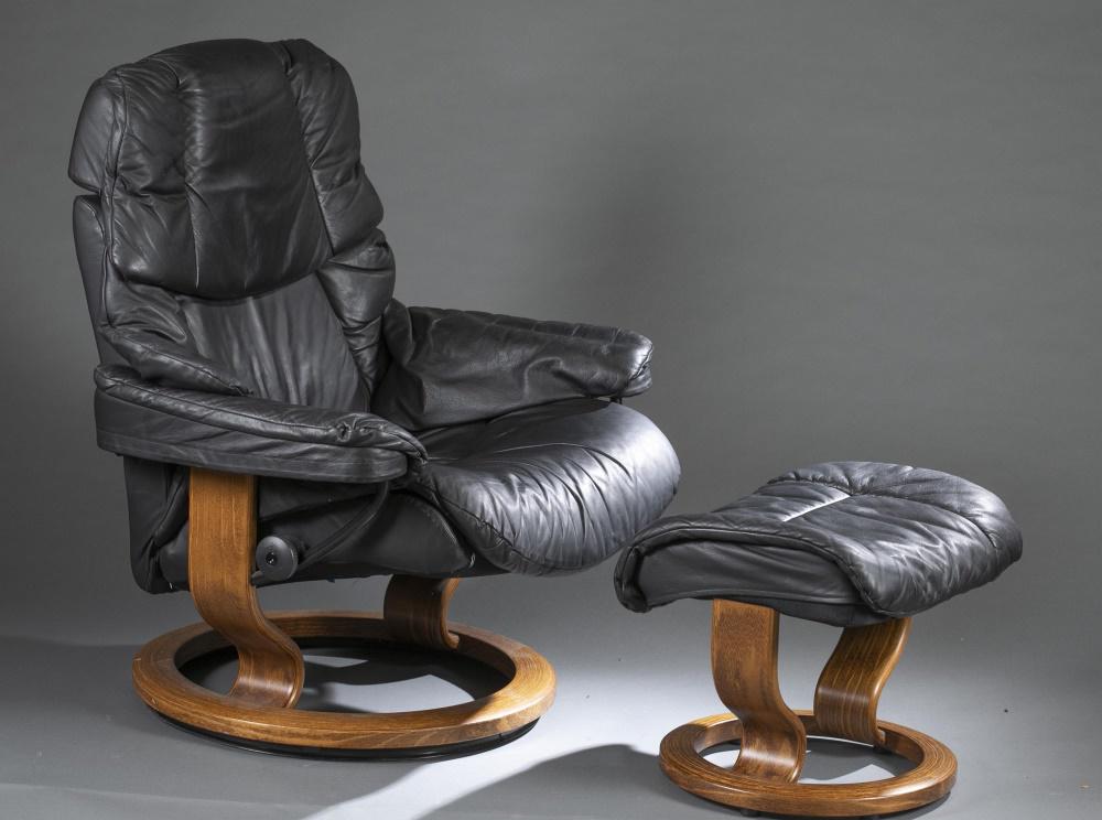 Ekornes,"Stressless" recliner and ottoman.: An Ekornes "Stressless" recliner and ottoman. Norway. 1970's. Black leather upholstery and bent plywood base. Marked on side of seat. Chair: 41" x 31" x 29". Ottoman: 16" x 22" x 16". Shipping: This l