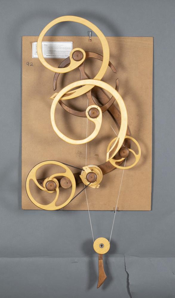 David Roy, "Duet", Kinetic wood sculpture.: Roy, David C. (American, b. 1952). "Duet." 1994. Kinetic wood sculpture. Hardwood plywood, bearings, string. Spiral wheels rotate freely when carrying wheel count-rotates. Three upper wheels as spiral