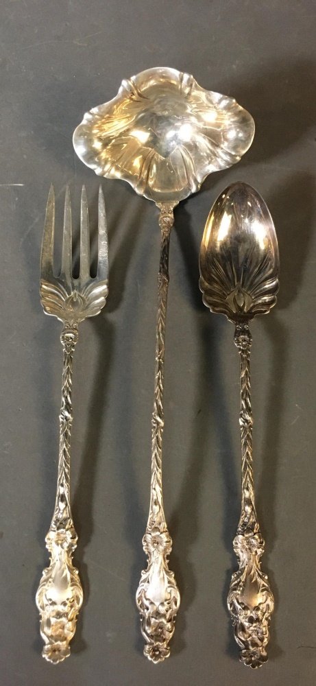 3 Whiting Manufacturing, "Lily" utensils.: A group of three Whiting Manufacturing "Lily" pattern, designed by Charles Osborne (1902), serving utensils. Marked on back. ++ One punch ladle. 14". ++ One fork. 11 1/2". ++ One spoon. 11 1/2". ++ Ap