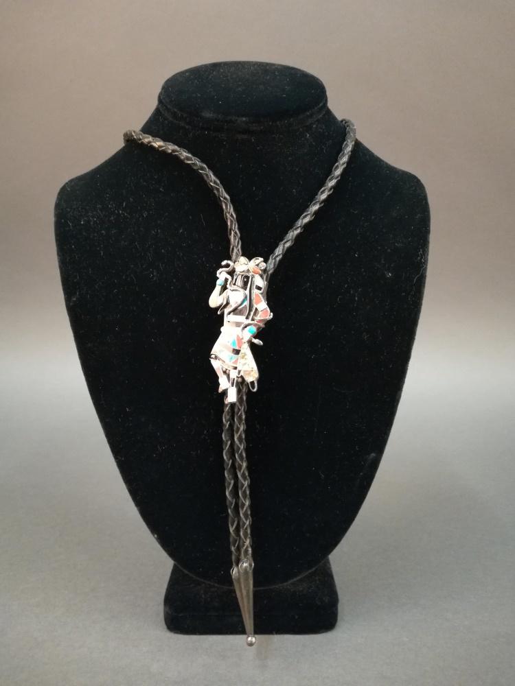 Zuni Inlay Snake Dancer Bolo Tie.: A Zuni Snake Dancer bolo tie with mosaic inlay. Silverplate, abalone, turquoise, and other stones. 2 1/2" x 1 1/4" x 1/2. Bolo length 36". Some stones have fallen out. Oxidation present to clasp.