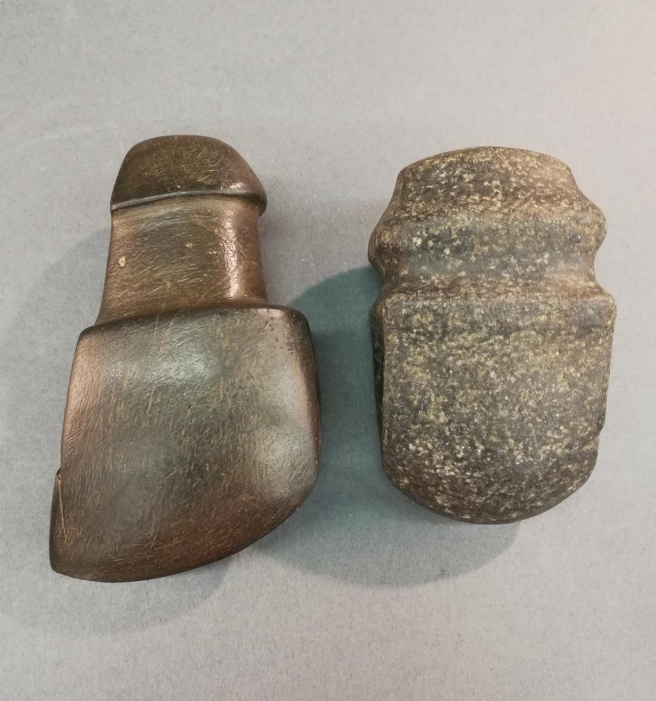2 North American Stone Axe Heads.: A group of two North American stone axe heads. ++ 4 1/4" x 2 1/2" x 1 1/2". ++ 3 1/2" x 2 1/4" x 1 1/2".