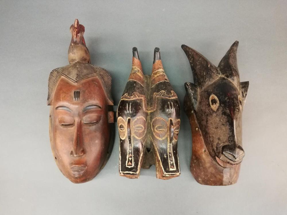 3 West African Style Masks. 20th c.: A group of three West African style masks. 20th century. Wood. Largest 16 x 6 1/2" x 6". Smallest 14" x 6 1/2" x 4 1/2".