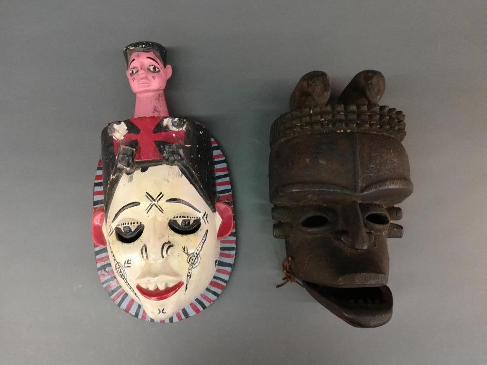 2 Nigerian Style Masks. 20th c.: A group of two Nigerian style masks. 20th century. Wood. West Africa. 15 3/4" x 8" x 3 3/4". ++ 12 3/4" x 7 1/4" x 5".