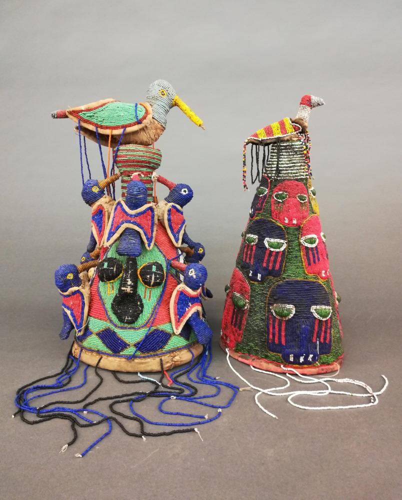 2 Yoruba Style Beaded Crowns. 20th c.: A group of two Yoruba style beaded crowns. 20th century. Cloth and beads. West Africa. ++ 17 1/4" x 9 1/4". ++ 15 3/4" x 7". Includes two display stands.