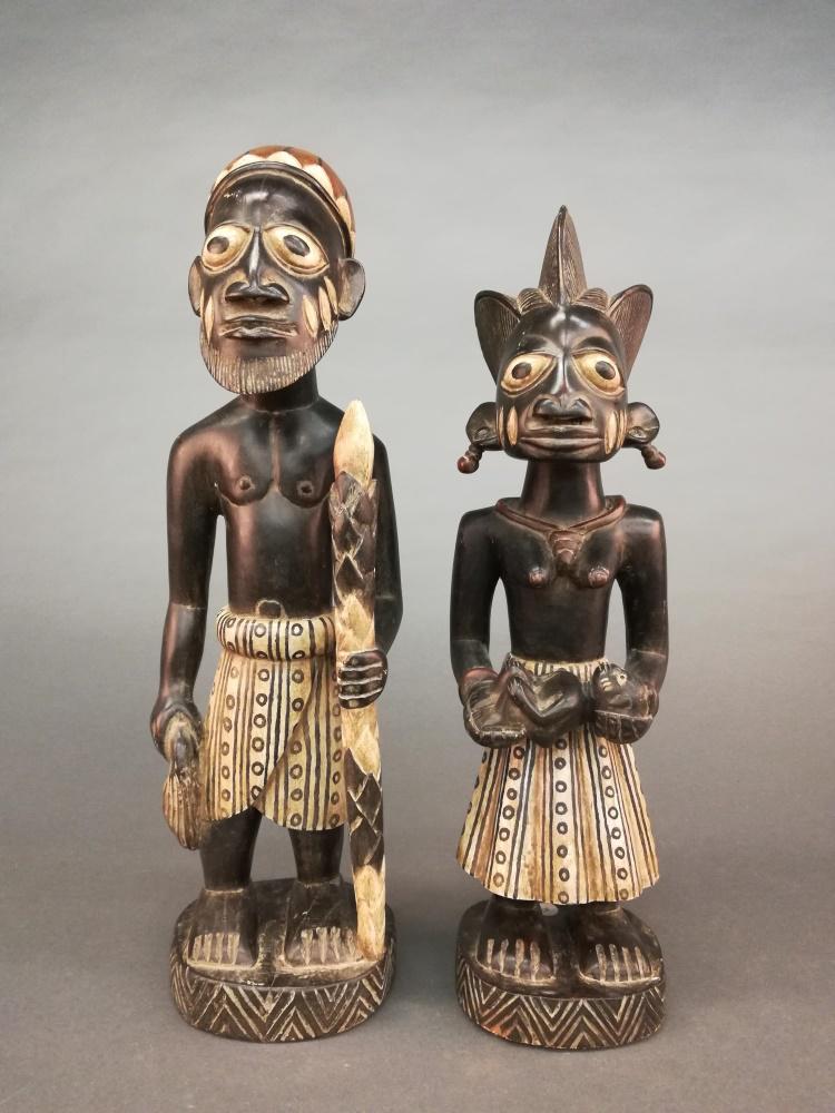 2 Yoruba Style Figures. 20th c.: A group of two Yoruba style figures. 20th century. Wood. West African. ++ 21 3/4" x 6 3/4" x 5 1/4". ++ 20 1/2" x 6" x 5 1/2".