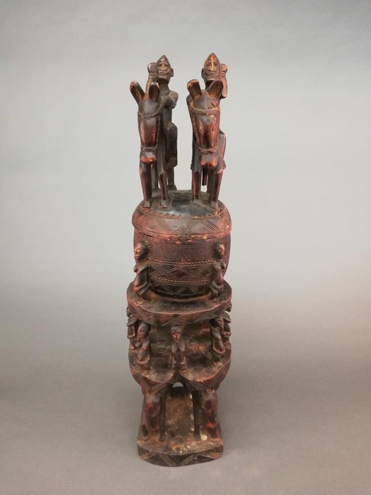 Dogon Style Vessel. 20th c.: A Dogon style lidded vessel. 20th century. Wood. 36 1/2" x 9 1/4" x 11".
