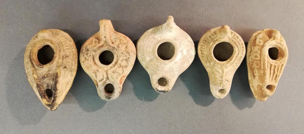 5 Middle Eastern Style Oil Lamps. 20th c.: A group of five Middle Eastern style oil lamps. 20th century. Largest 2 1/2" x 1 1/2" x 4". Smallest 1 1/2" x 2" x 3 1/2".