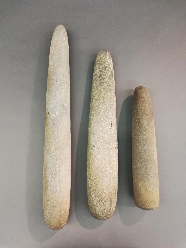 3 Stone Pestles.: A group of three stone pestles. ++ 22 1/2" x 3". ++ 19" x 3 1/2" x 1 1/2". ++ 13 1/4" x 2 3/4".