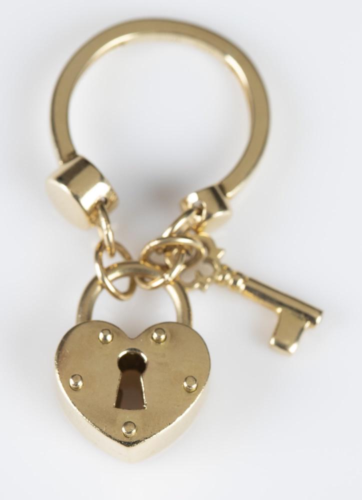 18k Gold lock and key pendant.: An 18k gold heart Lock and Key Pendant. Marked "18kt Italy" inside loop. Approximately 1 1/2" x 3/4" x 1/4"and 6.2g.