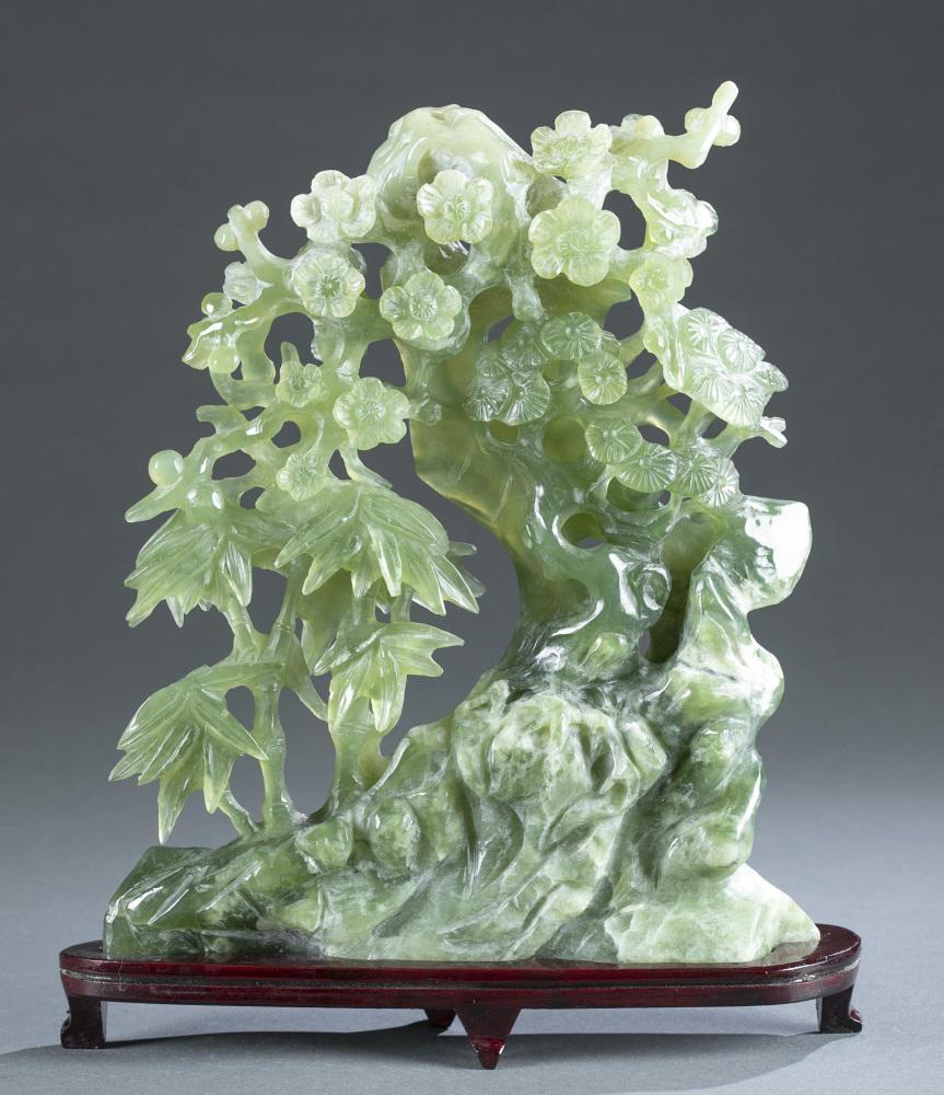 Large Chinese hardstone carving of trees.: A large Chinese hardstone carving of trees. Green hardstone depicting bamboo next to a flowering tree. Comes with wooden base. Approximately: 11" x 9 1/4" x 2". Provenance: From the collection of Anna