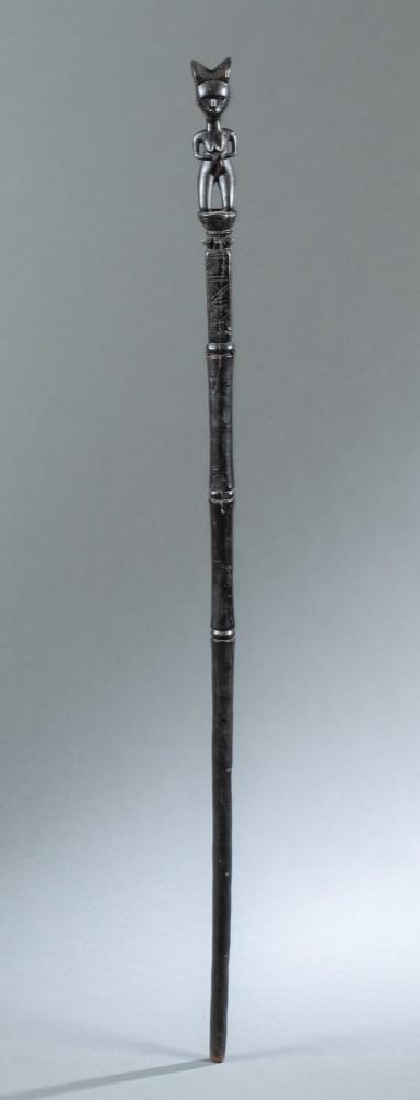 Kwere Staff, Tanzania, 20th c.: A Kwere staff. Tanzania, East Africa. 20th century. Wood. 44 1/4" x 2" x 1 3/4". Condition: includes a hanging contraption. Repaired cracks present throughout. Provenance: James Stephenson, New York.
