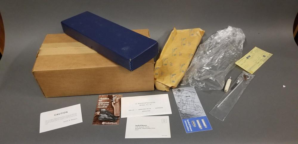 Box and paperwork for S&W 29 revolver: Box and paperwork for S&W 29-2 in ,44 magnum revolver. Includes two original cardboard boxes, paperwork, & cleaning tools. Does not include the firearm. Condition: Mildew formed on boxes.