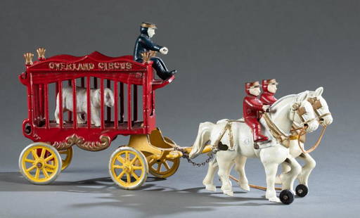 Kenton Cast iron Overland Circus 2-horse carriage.: A Kenton Hardware Co. cast iron Overland Circus two horse carriage. Includes bear, driver, and two riders. 6" x 14" x 3 1/2" Condition: Wear of paint consistent with age. Figures, horses and bear have