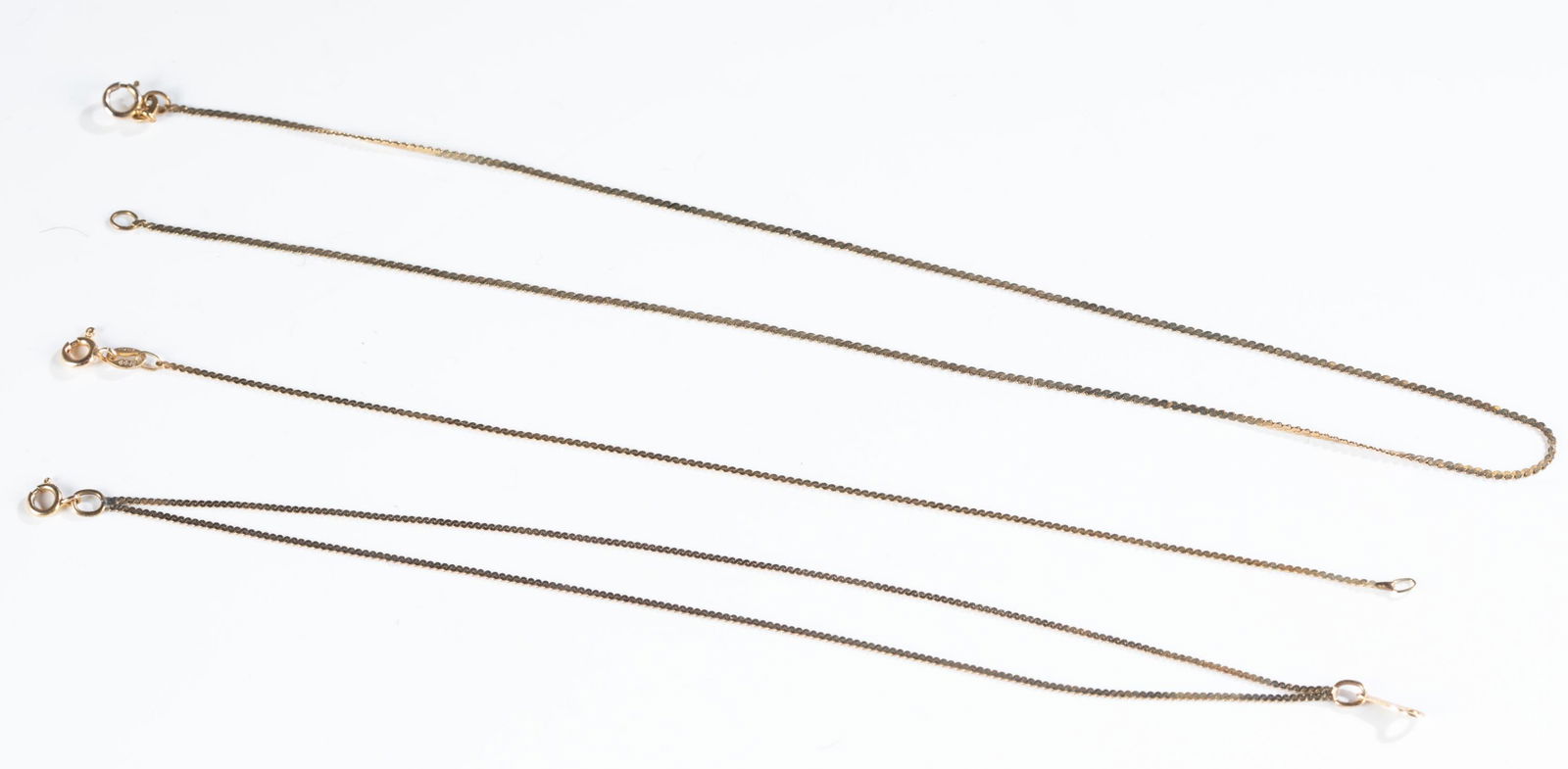 3 14k Gold bracelets and necklace.: A group of three 14k yellow gold flat S chain bracelets and necklace with springring clasps. Stamped on clasps. Approximately 4.7g. ++ Double chain bracelet. Stamped "14kt Italy". 7 1/4". ++Bracelet.