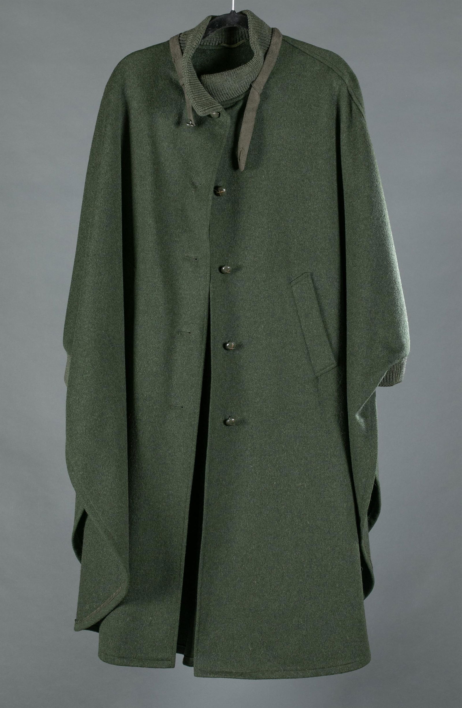 Burberry, green wool cape.: A Burberry green wool cape. Made in West Germany. Ribbed knit collar with suede collar strap. Five painted wooden buttons. Bust: Approximately 52". Length: 48". Condition: Wear to collar strap consist