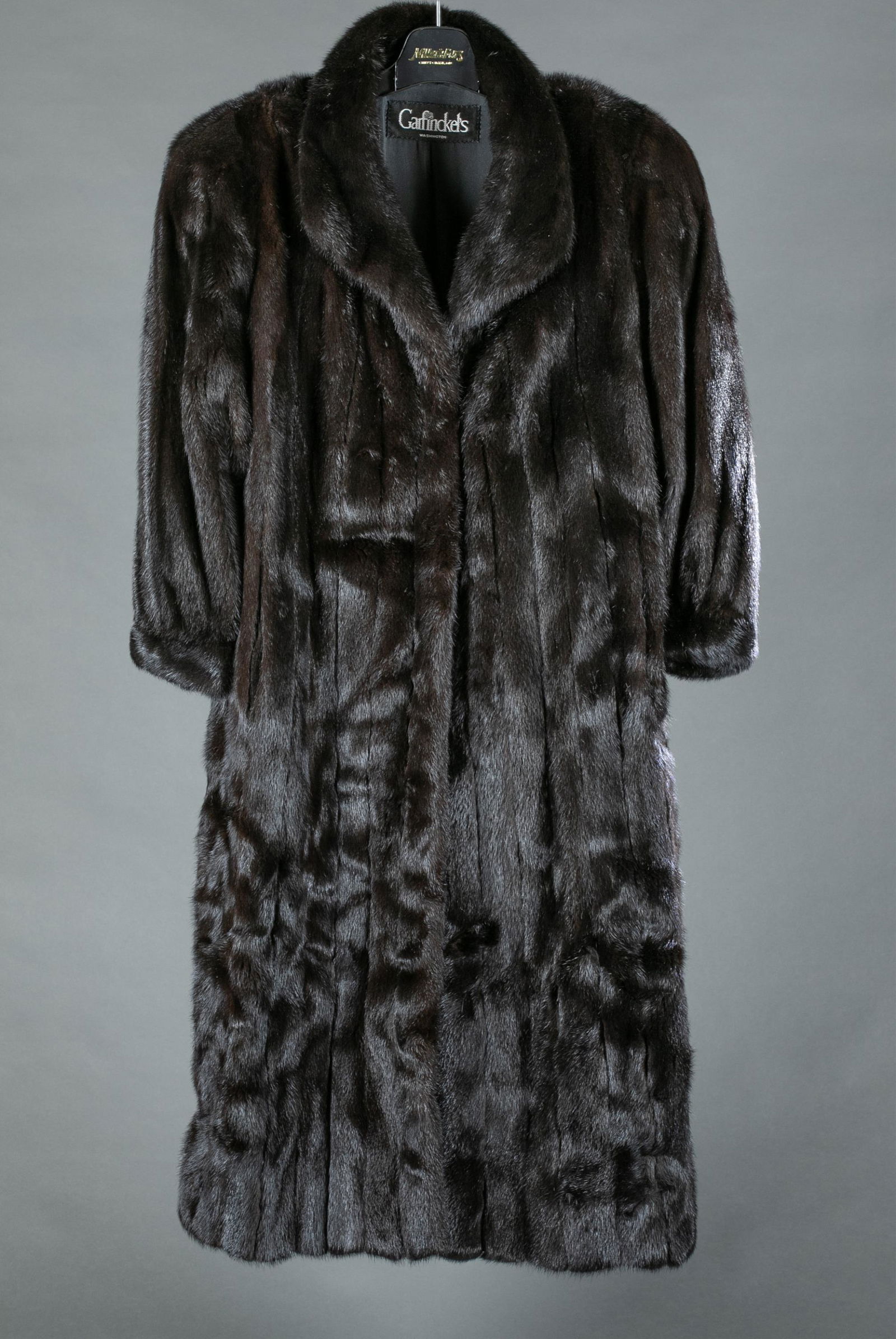 Brown mink, Garfinckel's, fur coat.: A brown mink fur full length coat by Garfinckel's. Washington D.C. Two fastener closure. Silk lining embroidered with previous owner name. Bust: Approx, 42". Length: Approx, 50".