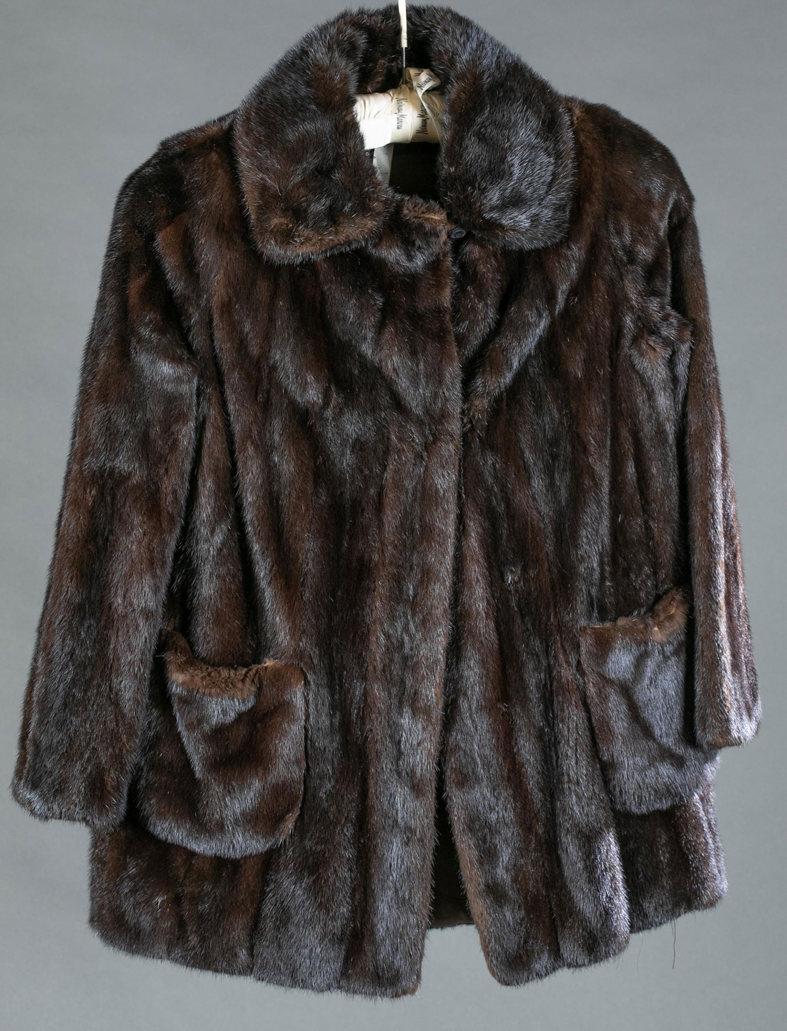 Rosendorf Evans mink coat.: A Rosendorf Evans dark brown mink coat with two front pockets. Two fastener closures. Lined interior and embroidered with original owner's name. Approximately: Length: 31" Bust: 37"