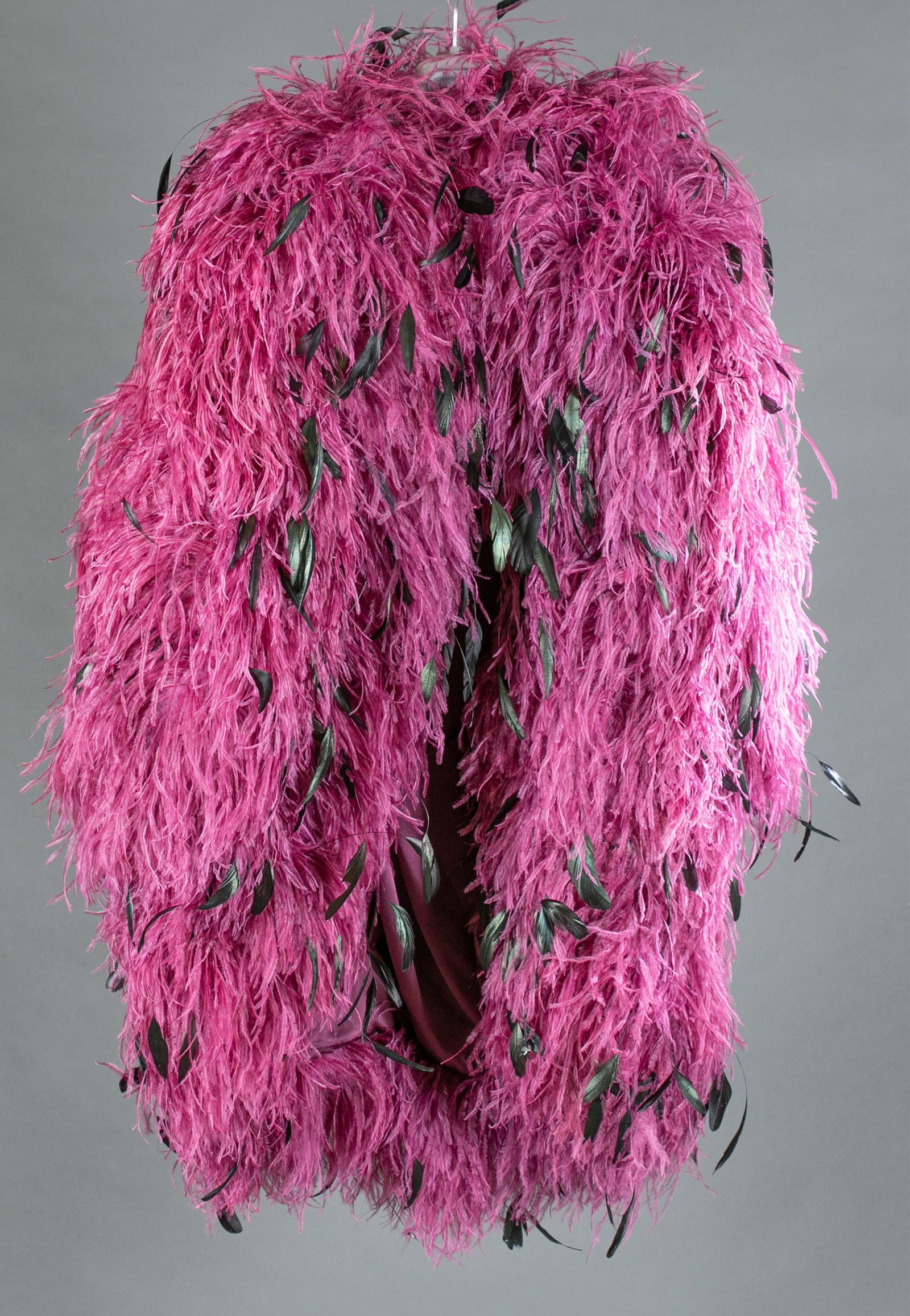 Bob Mackie feather coat.: A Bob Mackie purple and black feather coat. Silk lined interior. Approximately: Length:42". Bust:41".