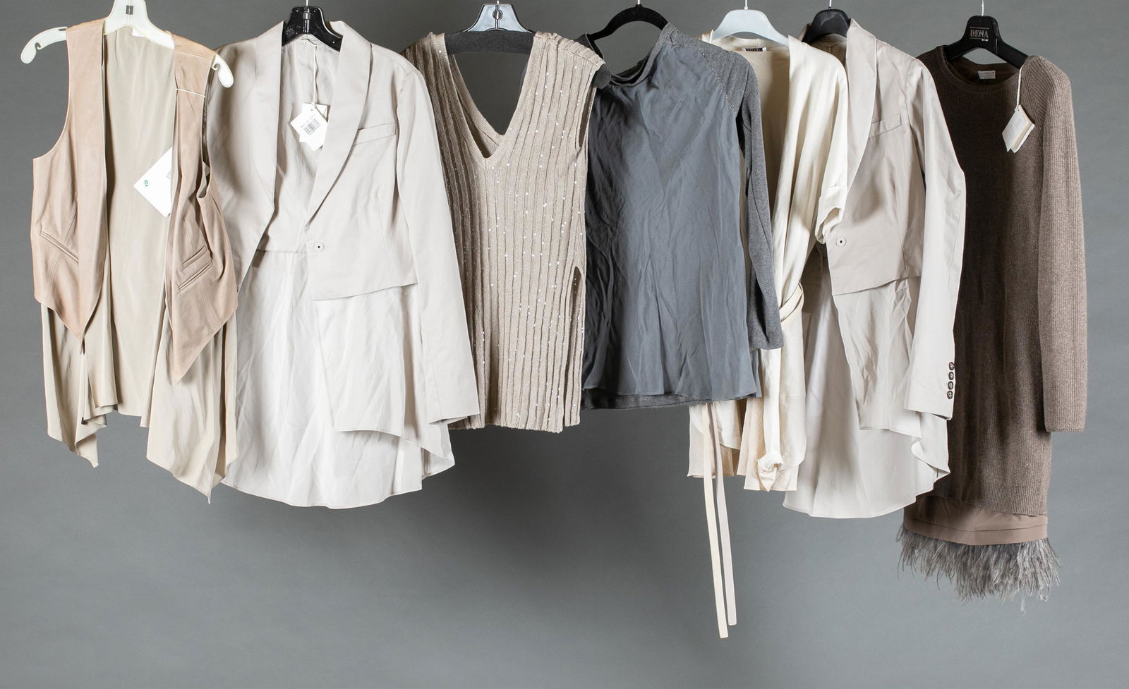 7 Brunello Cucinelli articles of clothing.: A group of seven Brunello Cucinelli articles of clothing. ++Light gray leather vest with cinched interior. Size 44. ++2 light gray blazers with shirt hemline. One size 44, one 42. ++Beige v-neck sweat