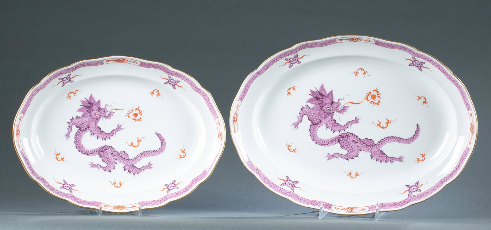 2 Meissen Ming Dragon platters, 19th c.: A group of two Meissen Ming Dragon Amethyst platters, circa 1852-1870. Both marked with under glaze crossed sword second mark. Smallest: 1 3/4" x 14" x 10 1/2." Largest: 2" x 16 1/2" x 12"