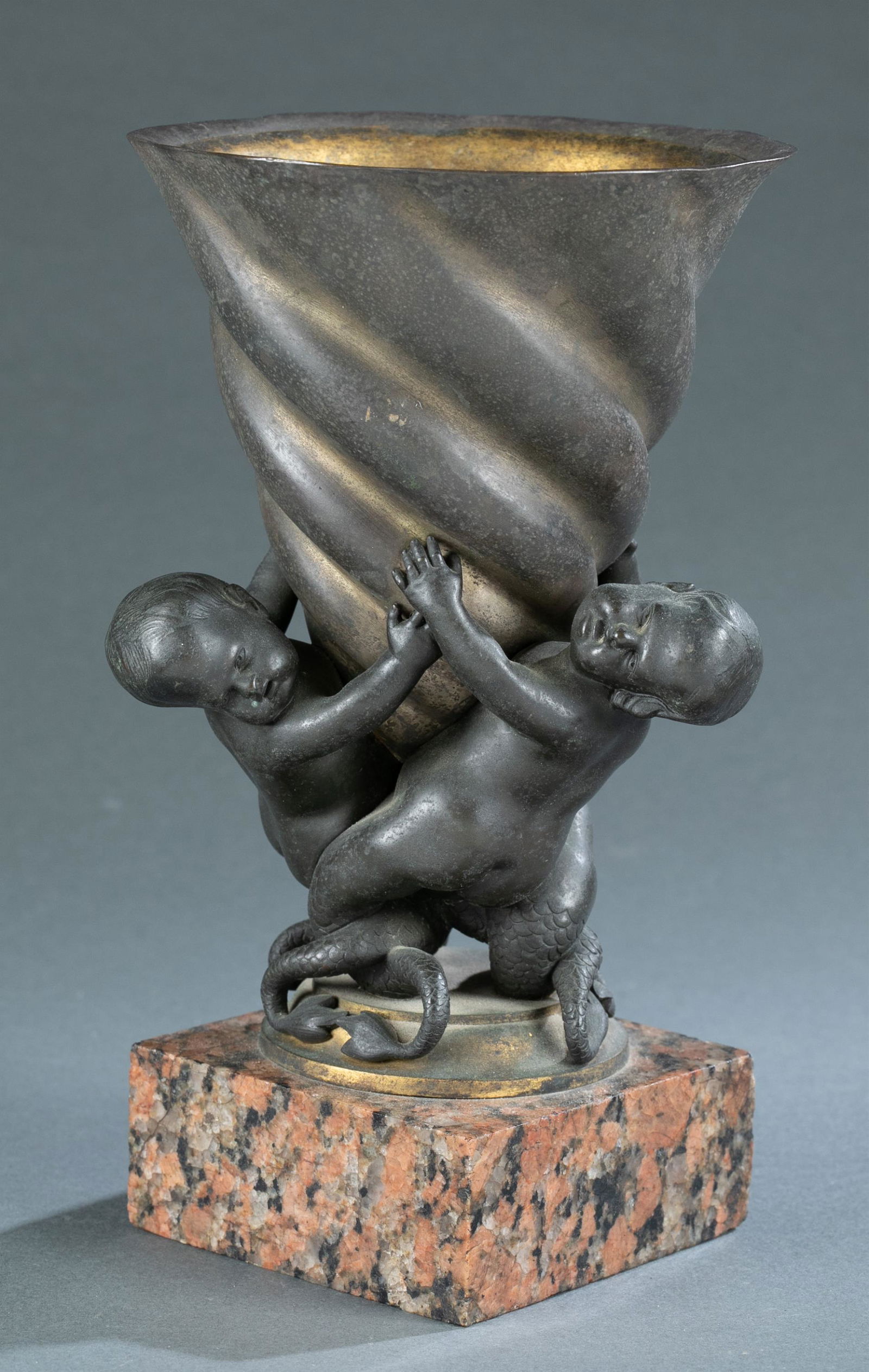 French Rococo bronze tritons vase on granite base.: A French Rococo bronze vase on granite base with three tritons intertwined around base of vase. Includes brass insert. 9 3/4" x 5 3/4" x 4". Shipping: This lot does not qualify for in house shipping.