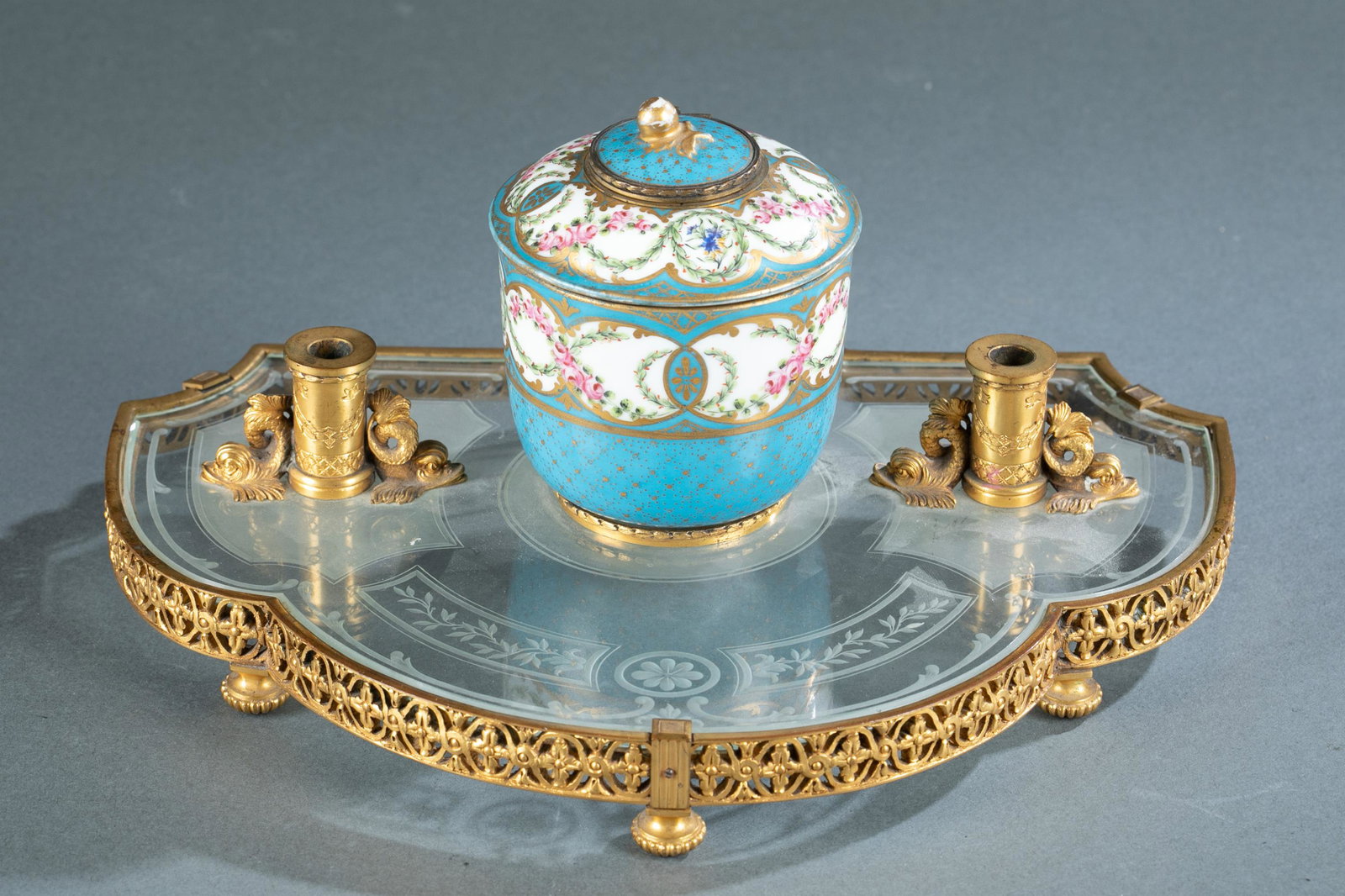 French E. Dreyfous inkstand.: A French Edouard Henry Dreyfous inkstand, circa 1880. The stand has a brass pierced skirt on reeded bun feet with an etched glass surface. Two pen stands with dolphin design flank a hand painted porce