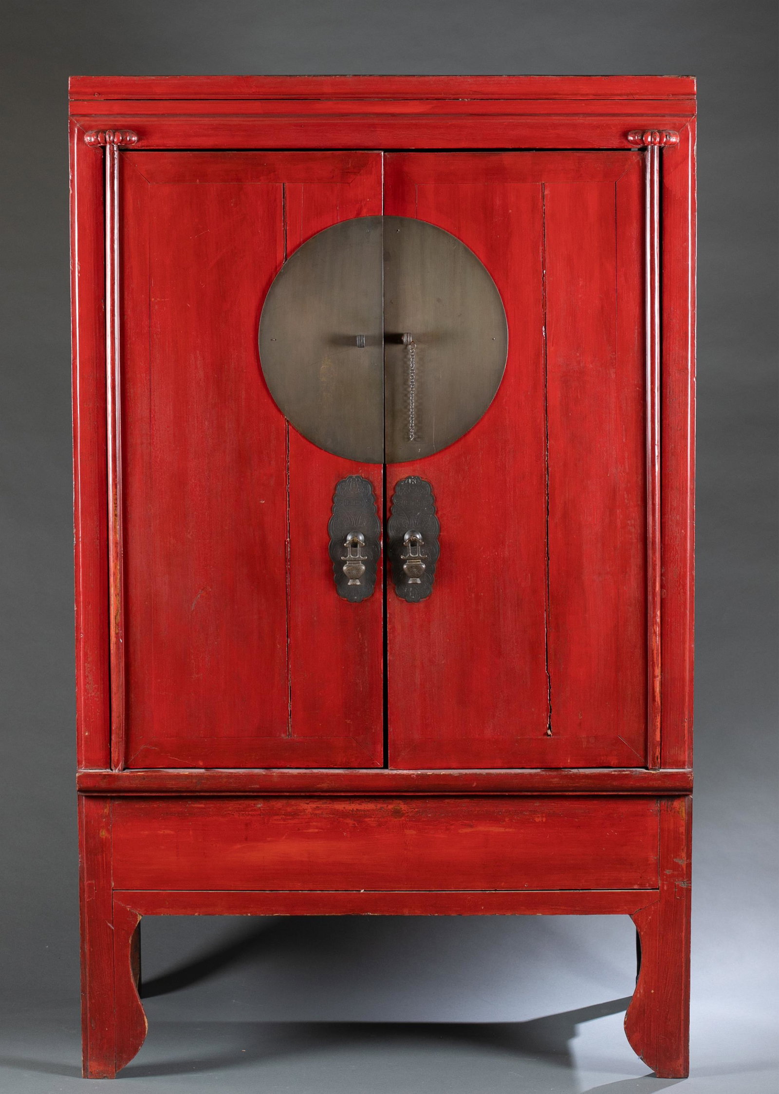 Chinese red lacquered elm wood wedding cabinet.: A Chinese red lacquered elm wood wedding cabinet, 19th century. With detachable doors. Two drawers and two removable shelves. With brass mounts. 68" x 42" x 24". Condition: Rubbing to the edge of cabi